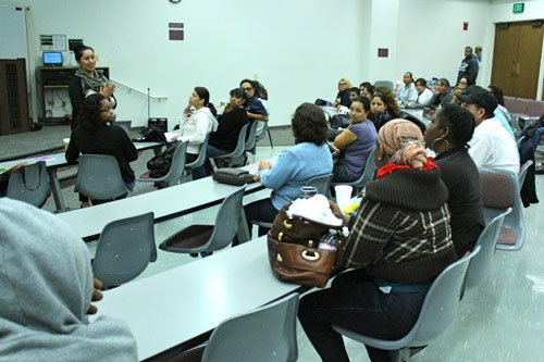 woman speaking to a room full of adults