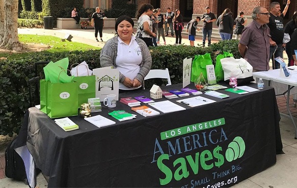 woman standing at a table representing America Saves