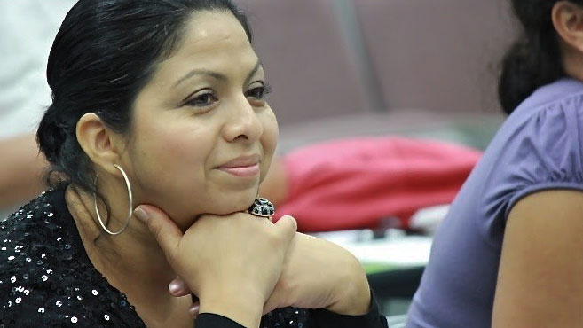 woman with gold hoop earring smiling